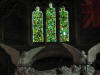 Tree of Life windows over an angel-flanked tomb